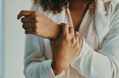 A woman holding her wrist in pain after an injury