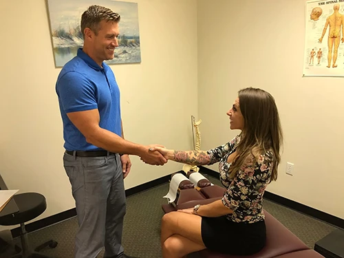 Dr. Brittin Beaulieu shaking a patient's hand in greeting during a consultation